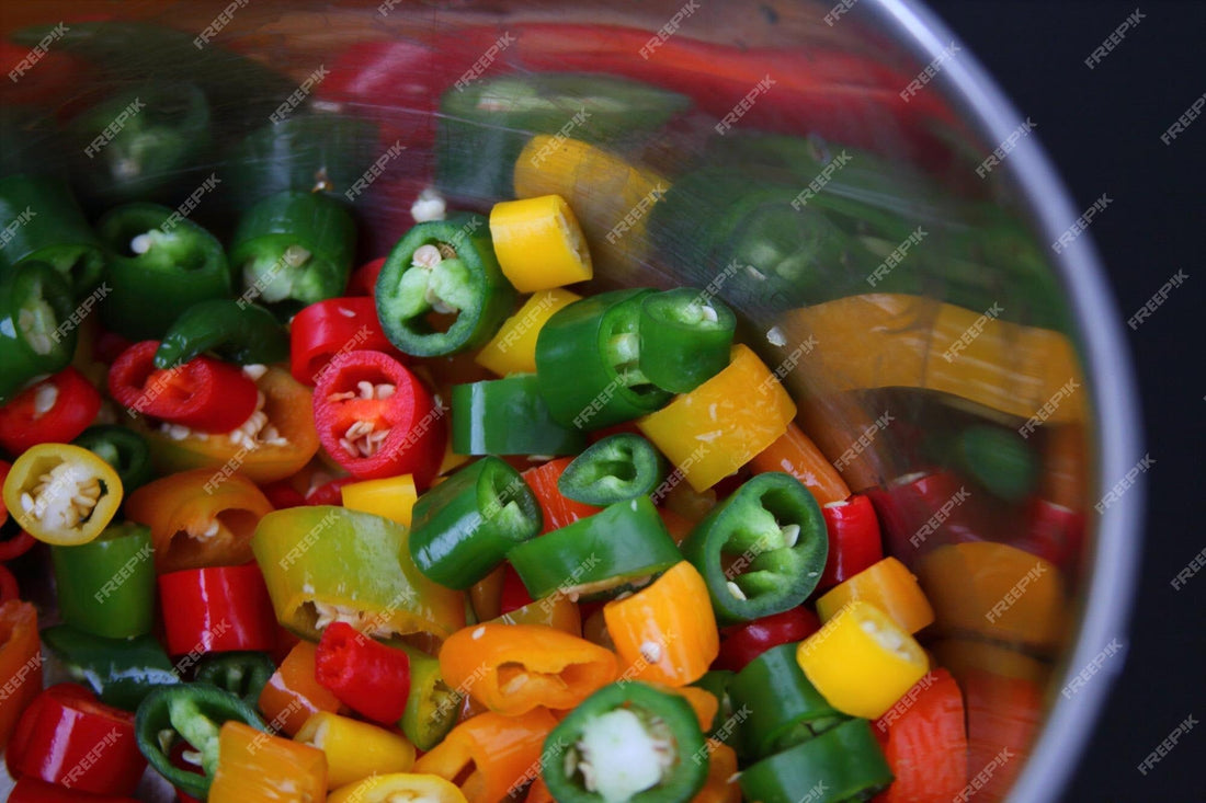 chopped chili peppers in pot for homemade hot sauce do it yourself