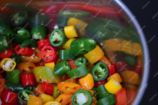 chopped chili peppers in pot for homemade hot sauce do it yourself