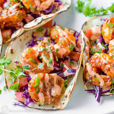 shrimp tacos aoli crema mayo sauce drizzle and best selling hot sauce