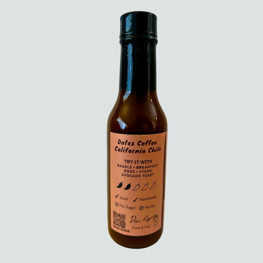 Experience the bold fusion of fresh roasted coffee and sun-dried desert dates in our artisan Coffee & Dates Hot Sauce. Made with locally sourced California chilis, this sauce delivers rich, deep flavors reminiscent of enchilada and mole sauces. 
 Perfect for elevating your favorite café staples like bagels, breakfast burritos, and savory pastries—or adding complex depth to a perfectly cooked steak.
Great on: Bagels, breakfast dishes, eggs, steak, avocado toast.
Ingredients: Vinegar, coffee, chilies, dates,