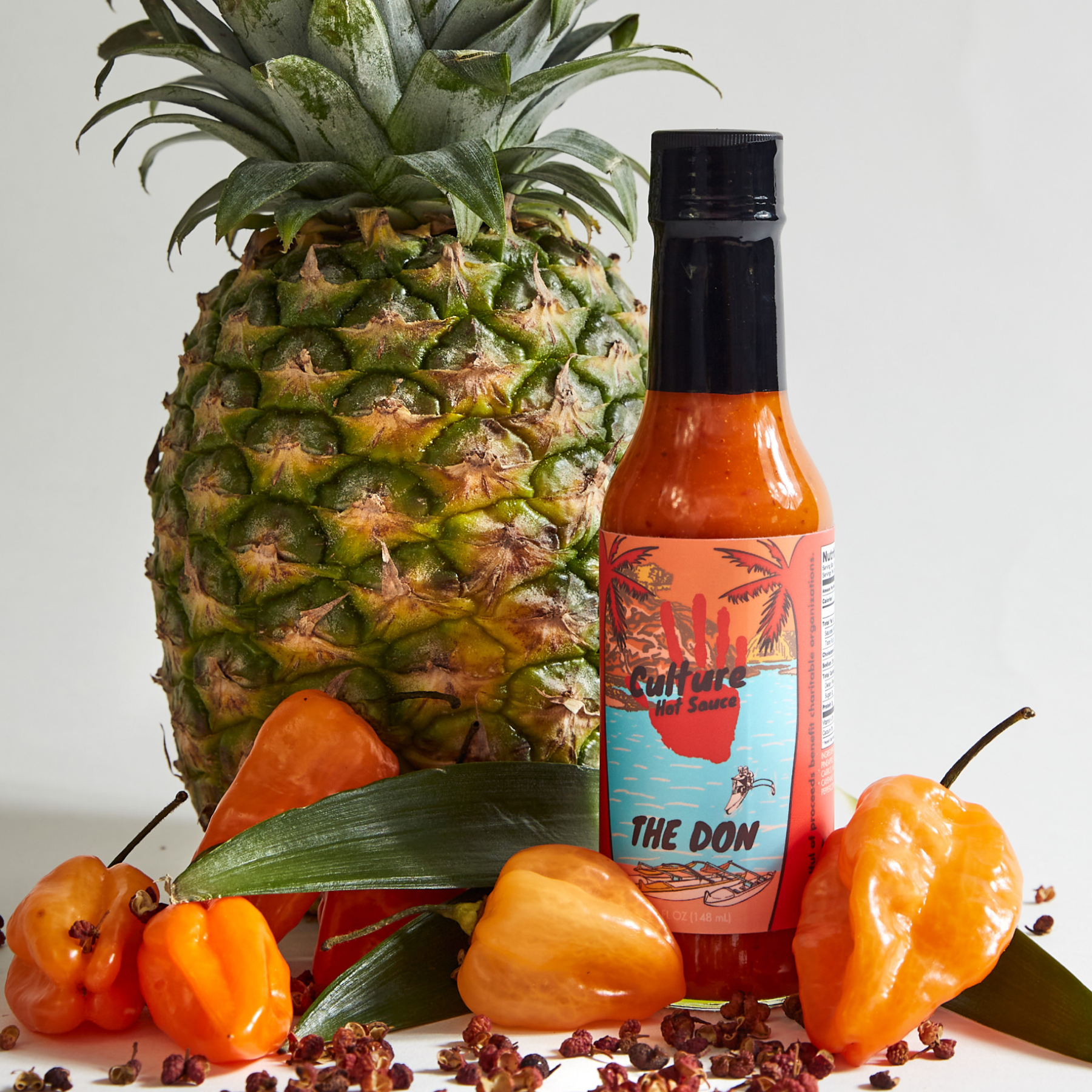 the don hot sauce, culture hot sauce's original hot sauce, bottle surrounded by ingredients, pineapple, habanero, mustard seed, bright and exciting flavor, classic flavor