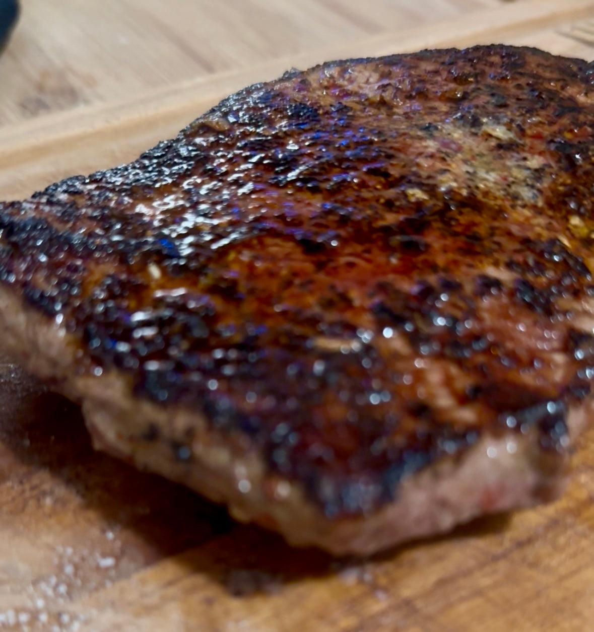 Cooked steak seasoned with Coffee Date dry rub, showcasing smoky coffee crust, sweet date caramelization, and California chile spice, grilled to perfection with rich, savory flavor.