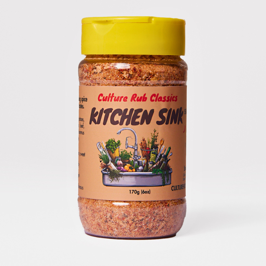 Kitchen Sink Rub– a warm, sweet, earthy, and pungent spice blend with mild chili, garam masala, garlic, onion, mineral salt, and aromatic spices.  This lightly salted, all-encompassing blend enhances lamb, potatoes, meats, stews, chicken, beef, cauliflower, squash, hummus, casseroles, vegetables, and ribs.  Perfect for adding depth and balance to any dish! spice jar front seasoning