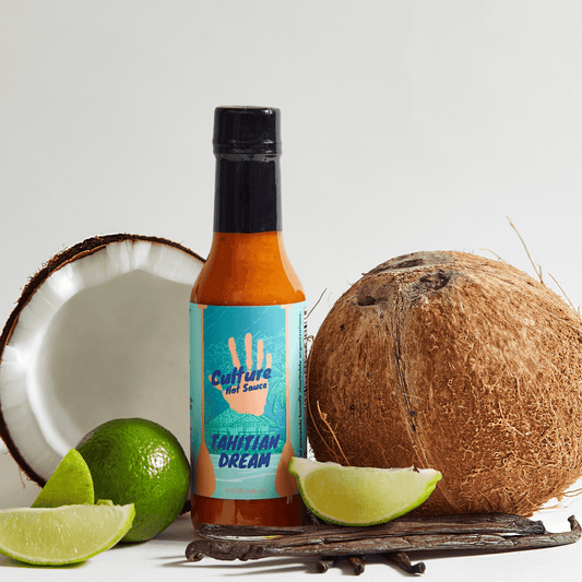 Tahitian Dream hot sauce, chef's favorite, coconut lime Tahitian vanilla bean surrounding the hot sauce bottle, key limes, extremely delicious, our most unique hot sauce