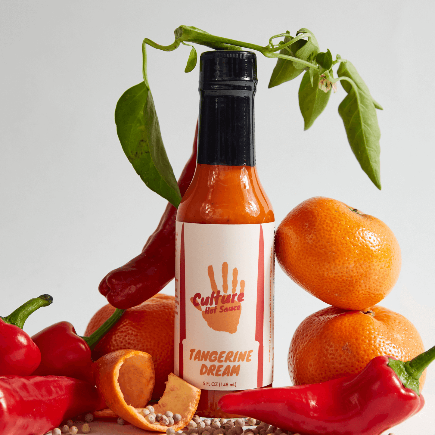Tangerine Dream Hot Sauce – A bright tangerine citrus base with a hint of yuzu, sweet peppers, and silky coconut cream for a smooth, slightly sweet flavor profile. This vibrant sauce is perfect for those who crave a balanced blend of citrusy brightness and savory depth.
Ingredients: Onion, Tangerine, Vinegar, Sweet Pepper, Coconut Cream, Garden Peppers, Sea Salt, Lemon, Lime, Paprika, Yuzu, White Pepper, Szechuan Peppercorn
Great On: Eggs, ceviche, fish, breakfast dishes, pork, hot dogs, quesadillas, chic