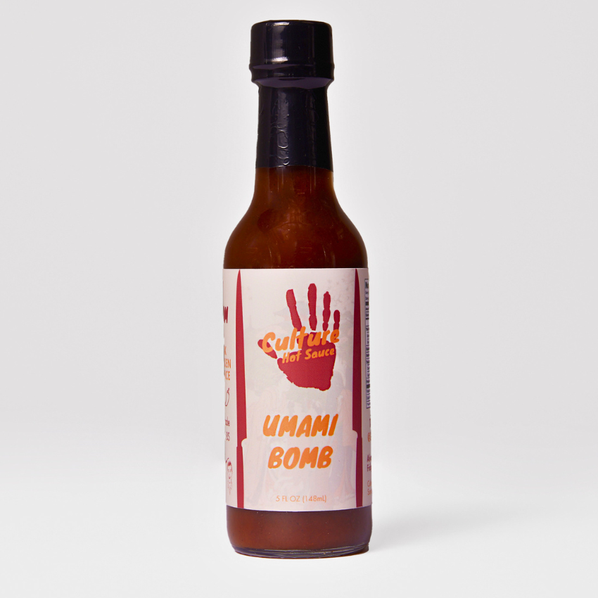 Umami Bomb Culture Hot Sauce bottle – a Japanese-style hot sauce with an Italian flair, featuring pickled black garlic, colatura di Alici, ponzu, and a premium dashi blend. Bursting with natural umami richness, deep, lingering flavor with no added MSG.
Great on: Poke, steak, fried rice, ramen, Hawaiian dishes, chicken, dumplings, hot pot.
Ingredients: Onion, rice vinegar, chili pepper medley, tamari (gluten-free), water, yuzu, fish sauce, sun-dried tomato, porcini, sea salt, dried cayenne, pickled garlic