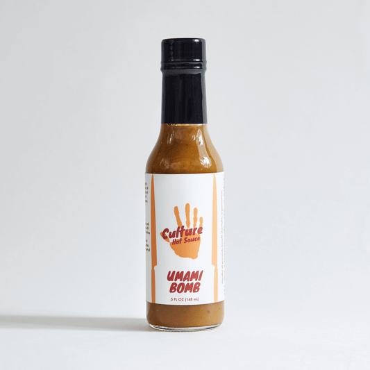 Umami Bomb Culture Hot Sauce bottle – a Japanese-style hot sauce with an Italian flair, featuring pickled black garlic, colatura di Alici, ponzu, and a premium dashi blend. Bursting with natural umami richness, deep, lingering flavor with no added MSG.
Great on: Poke, steak, fried rice, ramen, Hawaiian dishes, chicken, dumplings, hot pot.
Ingredients: Onion, rice vinegar, chili pepper medley, tamari (gluten-free), water, yuzu, fish sauce, sun-dried tomato, porcini, sea salt, dried cayenne, pickled garlic