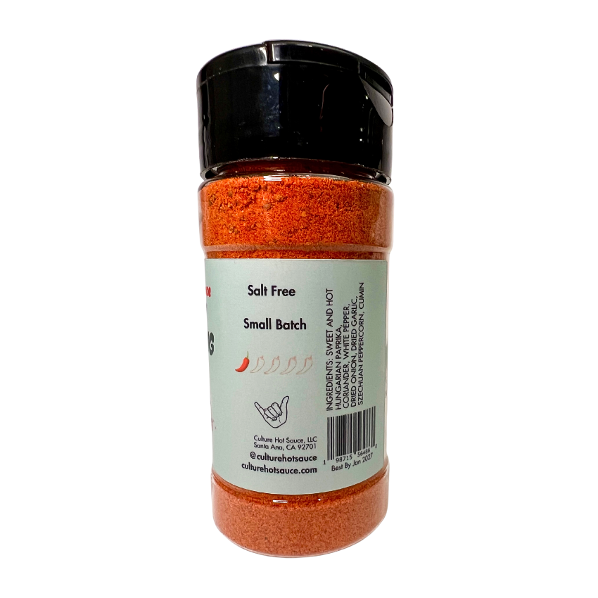 A vibrant, salt-free all-purpose seasoning blend featuring Hungarian paprika, dried garlic, dried onion, coriander seed, white pepper, and Szechuan peppercorn for a bold, zesty, and citrus-forward flavor with a lingering kick. Perfect as a rub or seasoning for salmon, chicken, fish, eggs, chili, vegetables, corn, ribs, beans, pork chops, breakfast, ceviche, and dips. Elevate your dishes with this aromatic, well-balanced spice mix! A tasty blend for everything from breakfast to dinner. Spice jar side image.